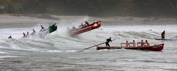 The surf boat fleet heading out through stormy conditions at Mount Maunganui's Main Beach